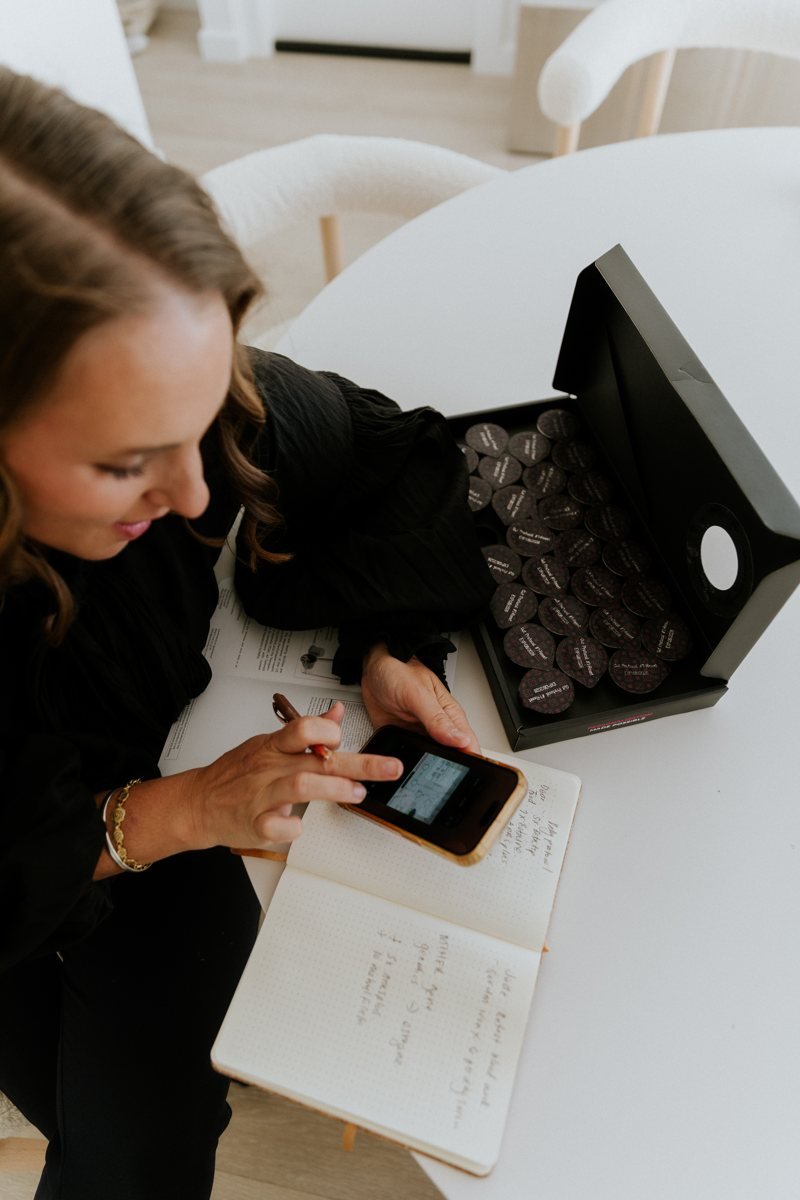 Shelley at her table with her notebook and a box of Bio Precision pods